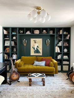 a living room filled with furniture and a guitar