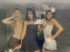 three women in bunny ears are taking a selfie