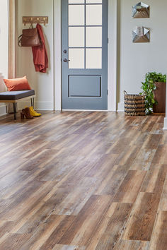 a wooden floor in front of a blue door