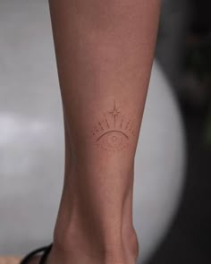 a woman's foot with a small tattoo on the side of her left leg