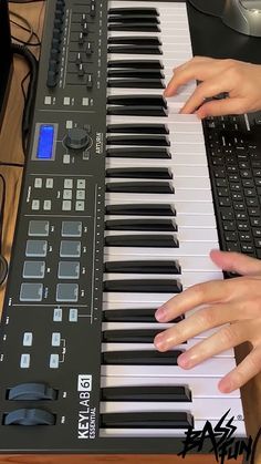 two hands are playing an electronic keyboard