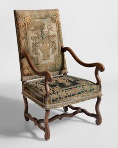 an old wooden chair with ornate carvings on it's back and armrests