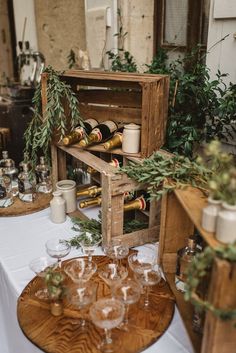 a wooden crate filled with wine glasses on top of a table