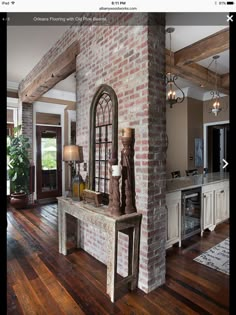 a living room filled with furniture and a fire place in the middle of a wooden floor