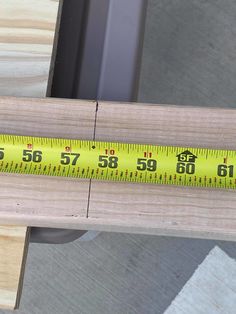 a wooden table with a measuring tape on it