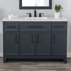 a bathroom vanity with a mirror above it