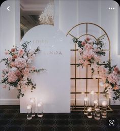 flowers and candles are on display in front of a sign