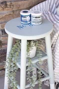 a small table with two cans of paint on it