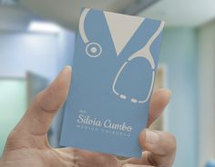 a person holding up a business card with a stethoscope on the front