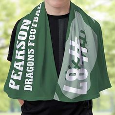 a young man wearing a green scarf with white letters on it and the words dragon's foot printed on it