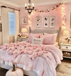 a bed with pink comforter and pillows in a bedroom decorated for fall or winter