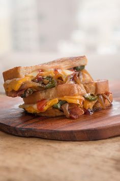 the sandwich is cut in half and ready to be eaten on the cutting board or serving platter