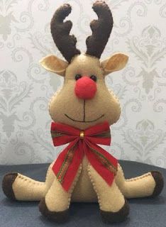 a stuffed reindeer with red nose and antlers sitting on top of a blue table