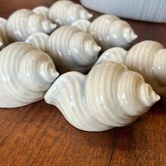 small white shells sitting on top of a wooden table