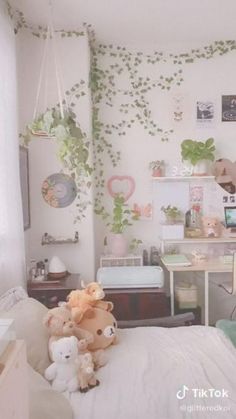 a bedroom with plants on the wall and stuffed animals