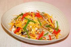 a white bowl filled with rice and vegetables