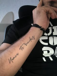 a man wearing a black shirt with writing on his arm and the words new friends written in cursive font