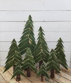 small trees made out of green leaves on a wooden table