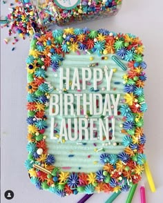 a birthday cake with the words happy birthday lauren surrounded by colorful sprinkles