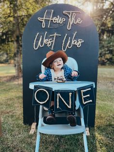 a little boy sitting in a chair with the words, how the west was one