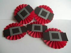 three red and gray paper fan shaped objects