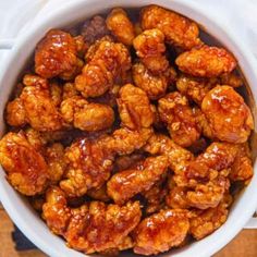 a white bowl filled with sweet and spicy chicken