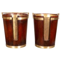 two wooden buckets sitting side by side on top of each other with gold trimming