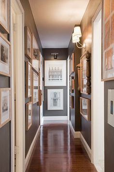 an empty hallway with pictures on the wall