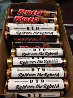 six rolls of rolo roll candy in a cardboard box with gold foil wrappers