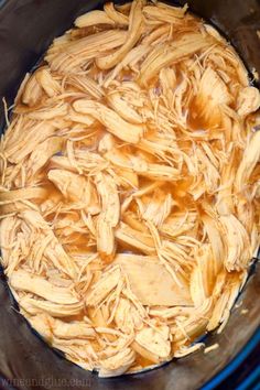 shredded chicken in a crock pot ready to cook