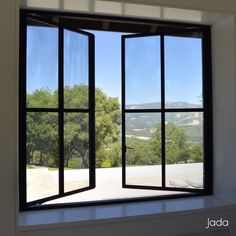 an open window with the view of trees outside