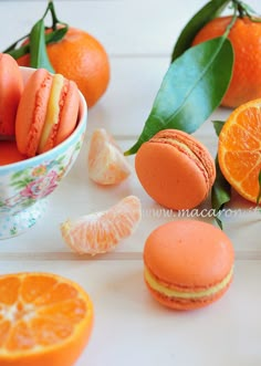 oranges and macaroons are arranged on a table