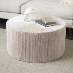 a living room with a couch, table and books on top of the coffee table