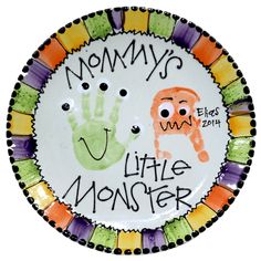 a plate with the words mommy's little monster and handprints on it