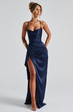 Get the silhouette of dreams in Helen, a premium stretch satin design with an elegant gown length maxi skirt. With a twist cowl neckline, cross over straps, lace up back and draped thigh high split, keep things ultra sleek with a high ponytail and pointed heels.     Colour: Navy.  Premium stretch satin fabric.  Fully lined.  Twist cowl neckline.  Cross over, adjustable straps.  Lace up back.  Draped thigh high split.  Asymmetric pleats to body.  Invisible zipper fastening.  Maxi length.   Size: Ty Ball Dresses, Year 10 Formal, Baddie Dresses, Prom Dress With Split, Wedding Guest Dress Ideas, Prom Dress Pictures, Satin Design, Split Prom Dresses, Semi Dresses