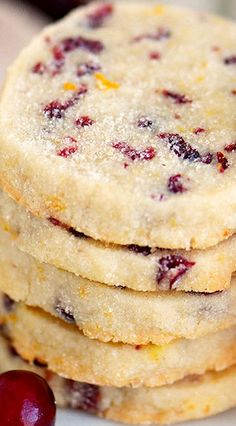 a stack of cranberry shortbread cookies sitting on top of a white plate