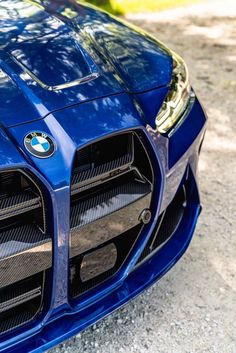 the front end of a blue sports car