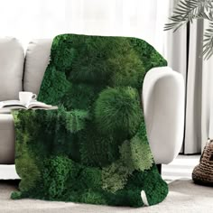 a living room with a couch, chair and table covered in green mossy plants