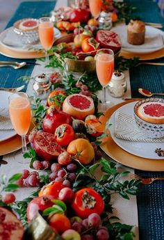 a long table is set with plates and fruit