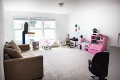 a living room filled with furniture and a baby crib