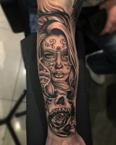 a woman's arm with a skull and roses tattoo on it