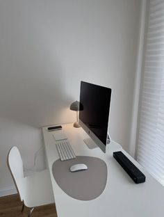 a white desk with a computer on it