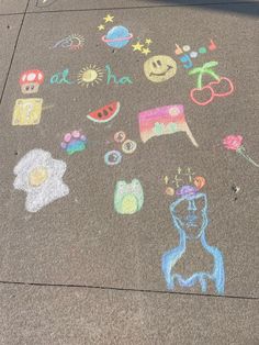 the sidewalk has drawings on it and is painted with chalk