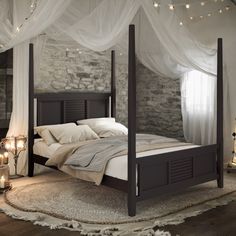 a bed with white sheets and pillows in a bedroom next to a window filled with lights