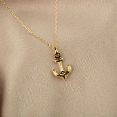 Our 14K Gold Mini Anchor Necklace is a splendid fusion of maritime charm and elegant design. This necklace features a delicately crafted mini anchor pendant, measuring 8mm by 12.7mm, making it an ideal accessory for those who adore the sea and its symbols. Whether you choose the classic elegance of Gold, the soft hue of Rose Gold, or the pristine beauty of White Gold, each option adds a unique touch to your ensemble. The necklace is crafted from authentic 14K gold, ensuring both quality and long Anchor Pendant, Anchor Necklace, Classic Elegance, The Necklace, Elegant Design, The Sea, 14k Gold, White Gold, Rose Gold