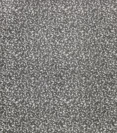 the texture of an old carpet is gray and white with small speckles on it