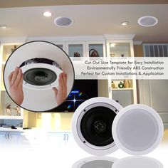 the ceiling speakers are white and have black trims on them, with two hands holding an object in front of them