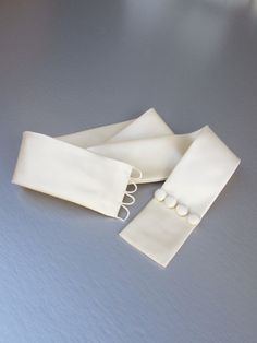 "This elegant simple bridal belt is beautifully made in silk Duchess satin. The belt is finished with the matching buttons and hand crochet loops in the back for the perfect detail. It comes in many color choices, please see the last photo for the color reference only. This belt measures 2\" wide and the length is finished to your measurements. * Please include your waist measurements in the notes during checkout and your belt will be finished at that length - If you would like to order the swat Fabric Belts For Women Fashion, Belt Dress Design, Diy Belts For Dresses Ideas, Cloth Belt For Dress, How To Make A Belt For A Dress, Wedding Dress Belt Ideas, Cloth Belts For Women, Waist Belt For Dresses, What To Do With Satin Fabric