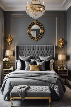 a bedroom with grey walls, gold accents and a chandelier above the bed