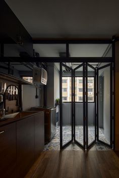 an open glass door leading into a kitchen